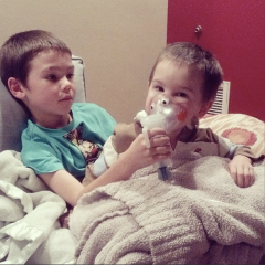 Caid helping out little bro Ian with  breathing treatment